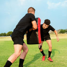 Ram Rugby Curve Hit Shield in black with orange accents, designed for rugby training, contact drills, and skill development